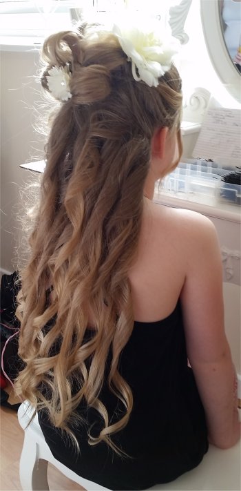 Bridesmaids hairstyle for long hair curly with a cream flower
