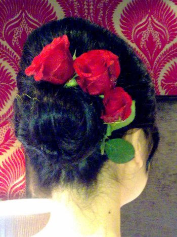 Low chignon with silk flower roses