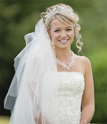 Curly up very natural wedding hair and makeup with crystal tiara and necklace
